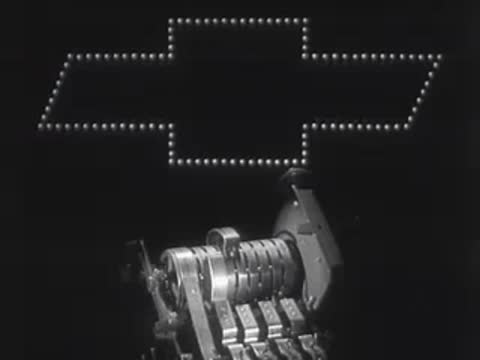 Animation showing a mechanical drum device below a glowing Chevrolet logo.