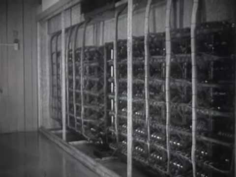 Rows of electrical relay equipment cabinets in an industrial control room.