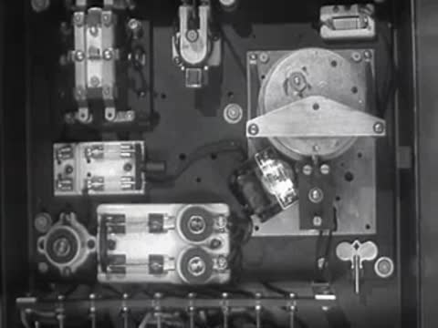 Detailed view of electrical relay switches and wiring on a panel.
