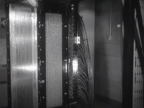 Vertical banks of electrical wiring and components in a large system.