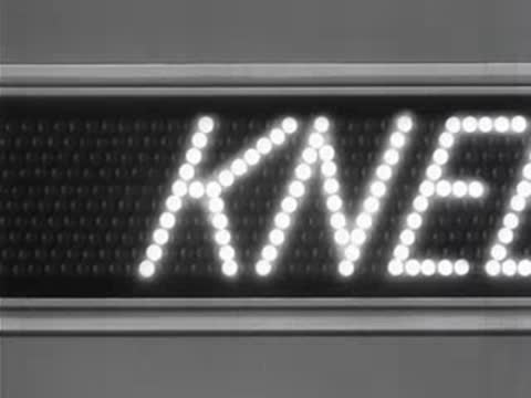 Close-up of an illuminated LED-style display spelling out words sequentially.
