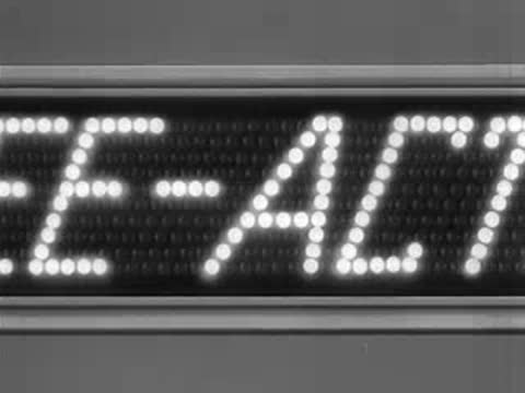 Close-up of a lit display board showing scrolling text words.