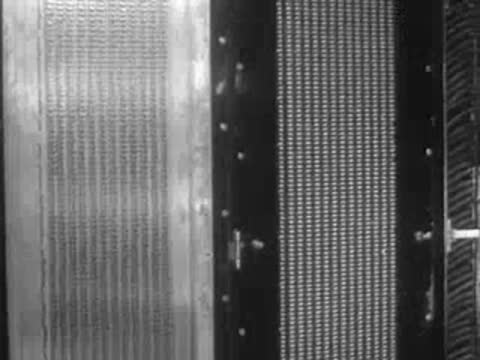 A lit display board viewed from an angle in an industrial setting.