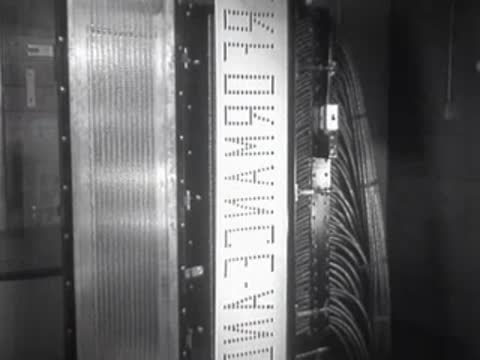 Vertical mechanical control strip with text passing through equipment banks.