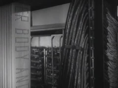 Vertical electrical panels and wiring harnesses inside a technical installation.