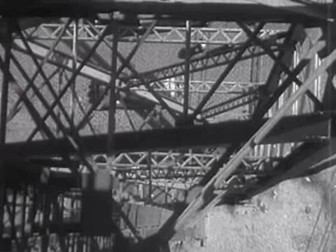 Bridge structure with city lights visible through the metal framework.