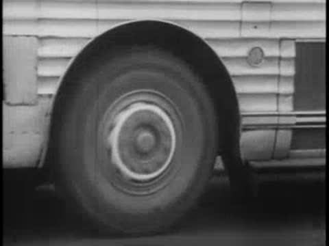 Close-up of bus wheels rolling on road, vintage transport.
