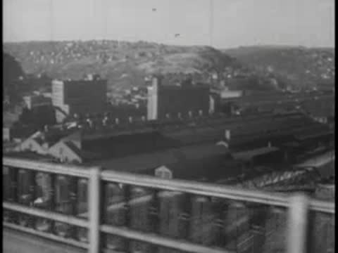 View from moving bus window, bridge railing and city, vintage.