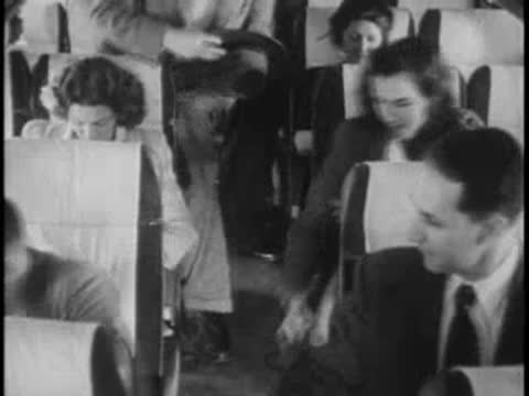 Passengers settling in bus seats, period clothing, travel.