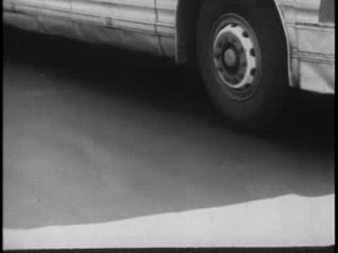 Close-up of bus wheels stopping at station, vintage transport.