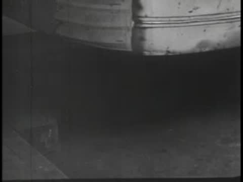Close-up of bus undercarriage and bumper stopping, vintage.