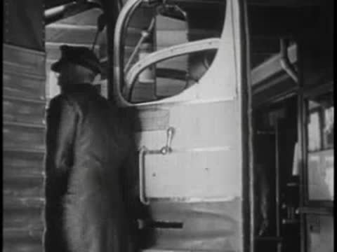 Bus driver standing by open door, waving goodbye, vintage uniform.