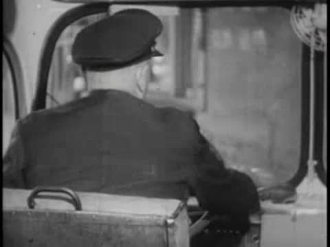 Driver takes his seat behind the steering wheel in the bus cabin