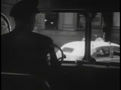 View from inside the bus looking out through the front windshield at street traffic
