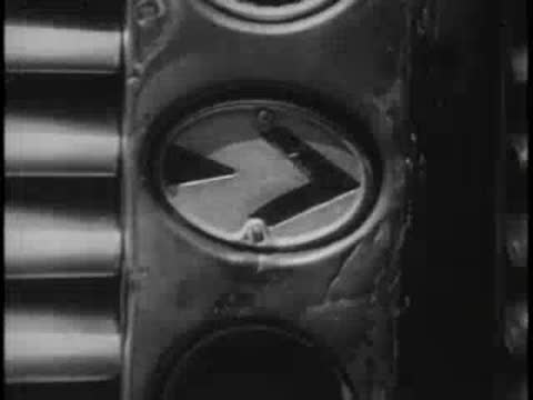 Driver’s hand operating bus controls, cut to exterior bus grill and headlights