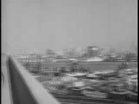 Scenic view of a city waterfront skyline from a bridge or highway.