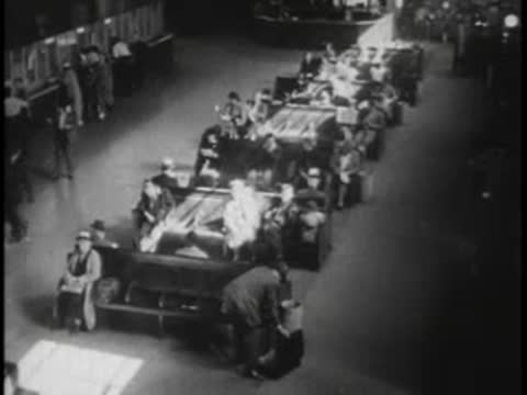 High-angle shot moving forward over passengers and luggage in a large terminal