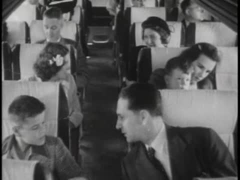 Passengers including a man, boy, and woman seated inside a bus.