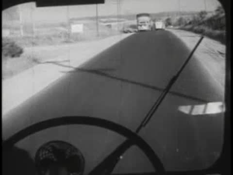 View from a moving vehicle passing a truck on a rural highway.