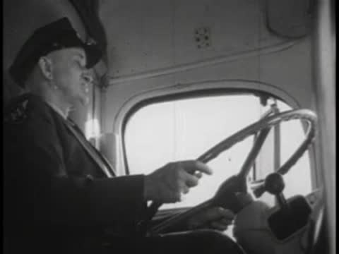 Profile view of a bus driver wearing a uniform and cap.