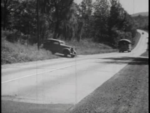 A car overtakes a bus on a two-lane rural highway.