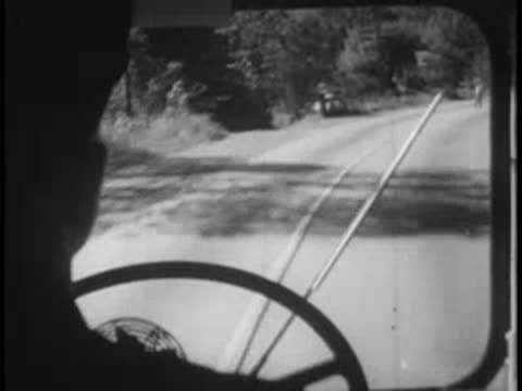 Bus tire rolling on road, view of road from window.