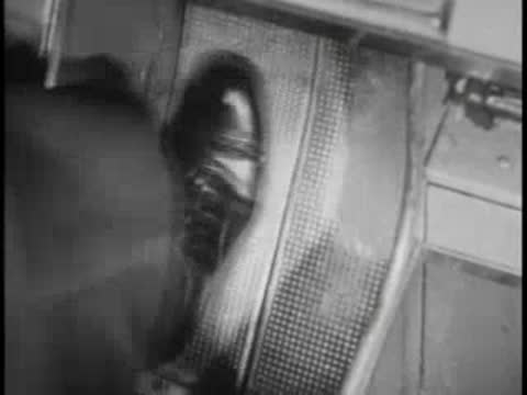 Bus driver pressing foot on accelerator pedal, vintage interior.
