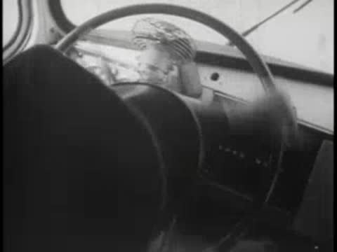 Bus driver turning steering wheel sharply, bus interior.