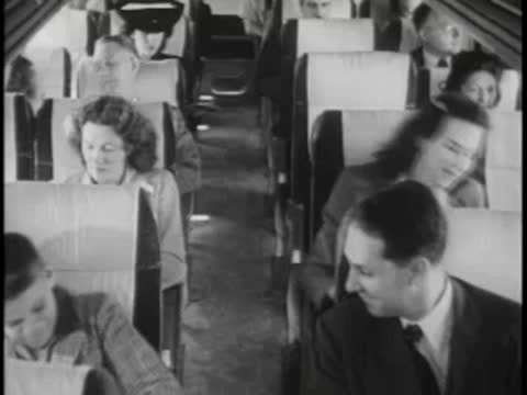 Passengers seated inside bus, talking, looking around, travel.