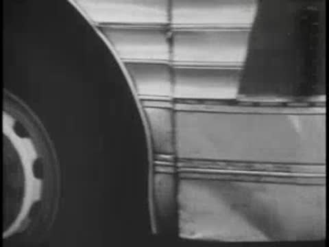 Close-up of bus front bumper and wheel, vintage vehicle.