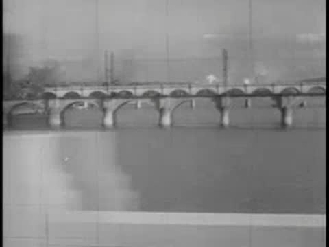 Optical dissolve effect showing the arches of a bridge over water.