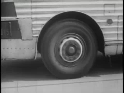 Close-up of a moving bus wheel and tire spinning on the road surface.