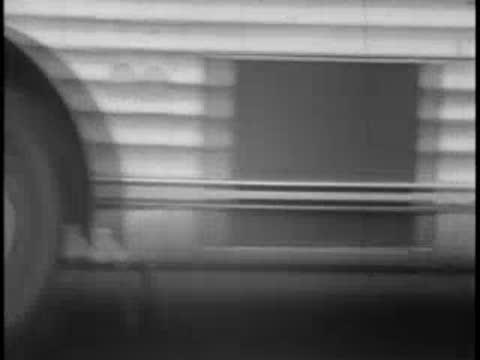 Close-up view of the side of a moving bus traveling along the highway.