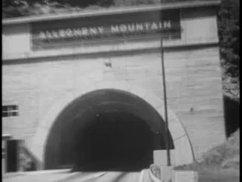 Approach to the Allegheny Mountain tunnel entrance with sign visible above arch.