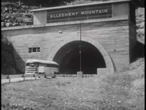 A bus exiting the Allegheny Mountain tunnel into the bright daylight.