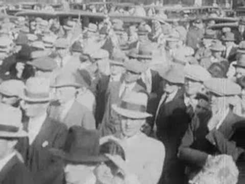 Large crowd of people in hats gathered closely together outdoors.