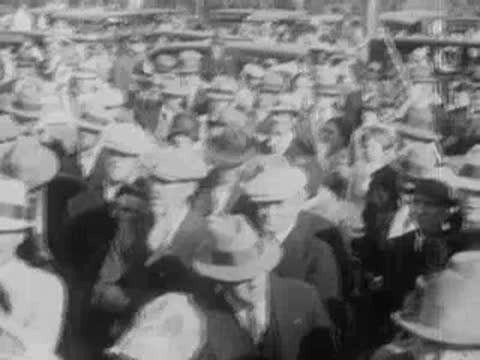 Large crowd of people wearing hats gathered for a public event.