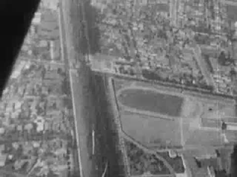 An aerial shot looking down at residential streets and a park.