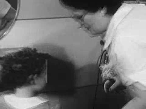 Stylist working on a young girl's curly hair.