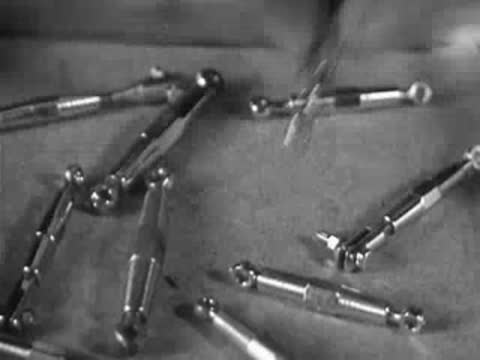 Close-up shows small metal turnbuckles and the assembly of a model mast.