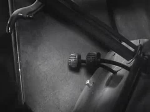 Foot operates car pedals at night from the driver's perspective.