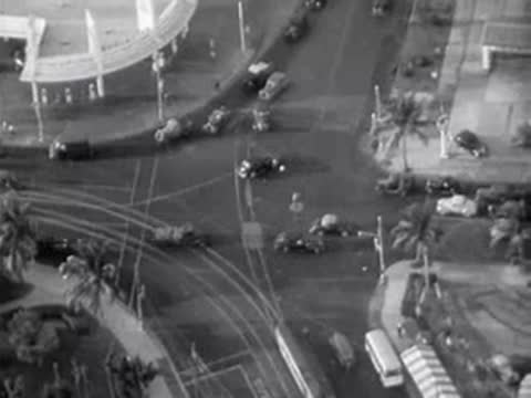 Aerial view of a busy traffic intersection with cars and buildings