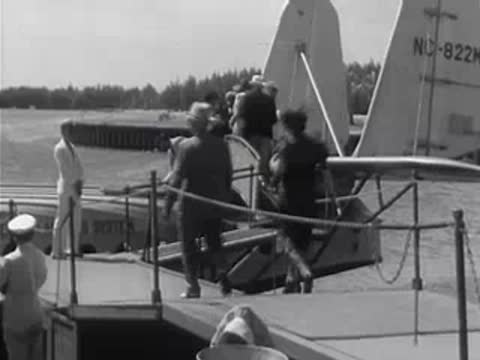Passengers boarding a Pan American Airways seaplane via a ramp