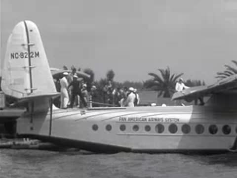 Pan American Airways seaplane on the water with passengers near the door