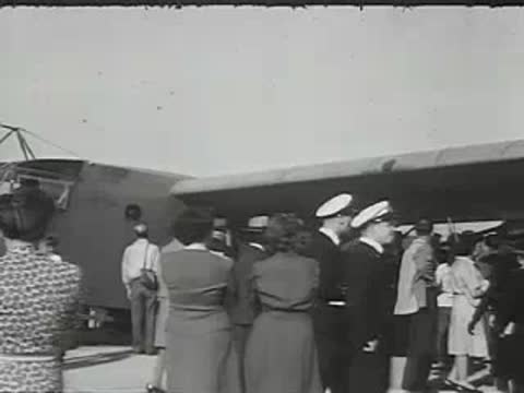 Passengers walking toward the entrance of an airplane.