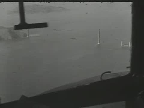 Cockpit view looking through windshield toward water landscape.