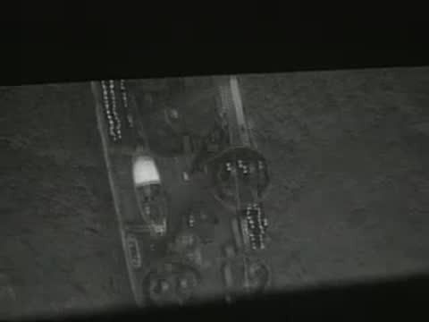 aerial view of an industrial area with smoke rising