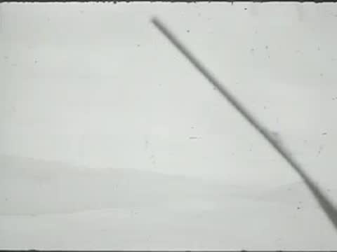 An aerial view from an aircraft window with a wiper visible.
