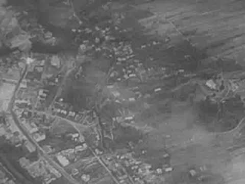 crowd of refugees and aerial view of a bombed town