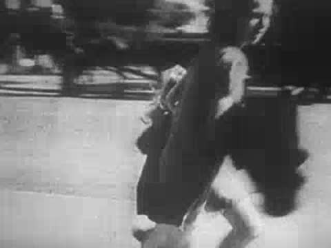 young girl running down a city street during a wartime event
